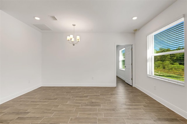 5213 Patano Loop, Palmetto, FL 34221 - spare room featuring a chandelier, light wood finished floors, recessed lighting, and baseboards