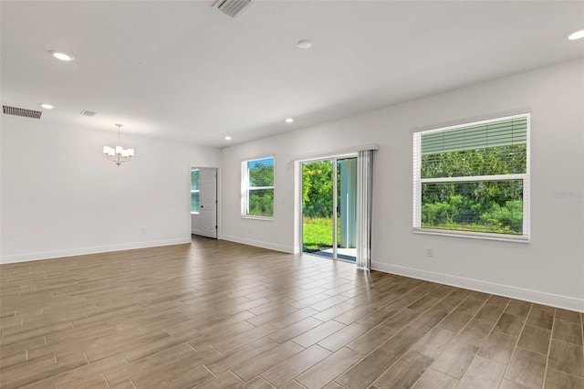 5213 Patano Loop, Palmetto, FL 34221 - spare room with a chandelier, recessed lighting, baseboards, and wood finished floors