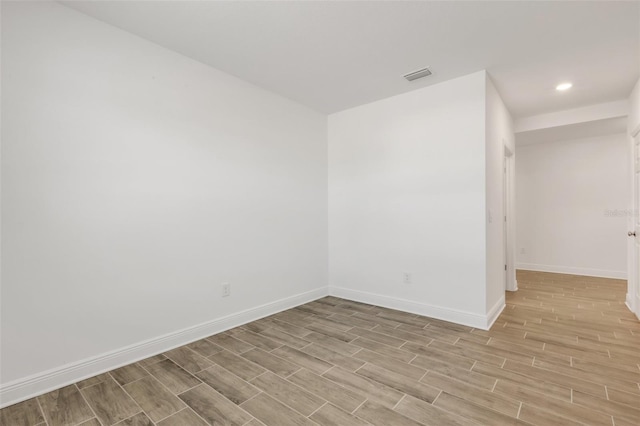 5213 Patano Loop, Palmetto, FL 34221 - unfurnished room with light wood-style floors, baseboards, and recessed lighting