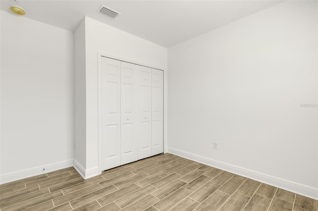 5213 Patano Loop, Palmetto, FL 34221 - unfurnished bedroom featuring wood finish floors, baseboards, and a closet