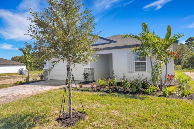 5213 Patano Loop, Palmetto, FL 34221 - view of property hidden behind natural elements featuring driveway, stucco siding, a garage, a front lawn, and roof with shingles