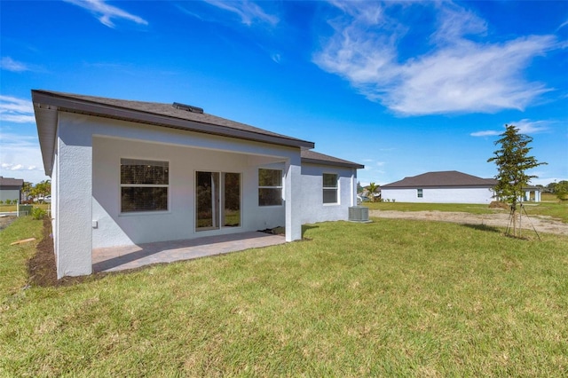 5213 Patano Loop, Palmetto, FL 34221 - rear view of house featuring stucco siding, a patio, a lawn, and central AC