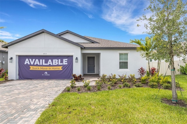 5213 Patano Loop, Palmetto, FL 34221 - ranch-style house featuring an attached garage, decorative driveway, a front yard, stucco siding, and roof with shingles