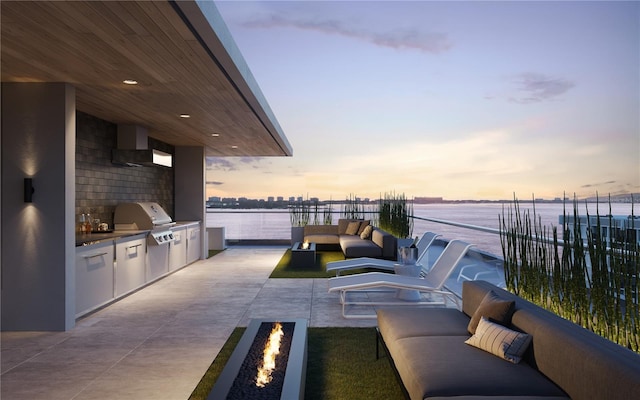 688 Golden Gate Pt Unit 201, Sarasota, FL 34236 - view of patio with an outdoor living space with a fire pit and a water view