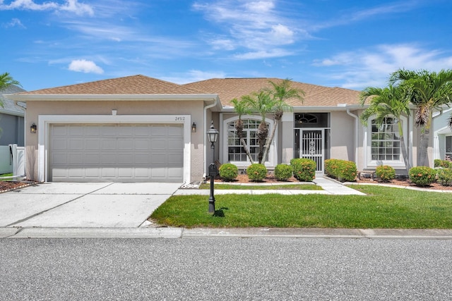 24512 Bramhope Ct, Punta Gorda, FL 33980 - ranch-style house with stucco siding, a front lawn, concrete driveway, and an attached garage