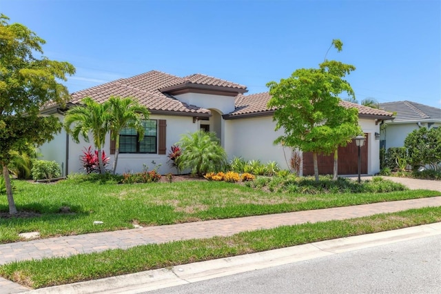 8020 Clearwater Ct, Sarasota, FL 34241 - mediterranean / spanish home with a garage, a tile roof, a front yard, and stucco siding