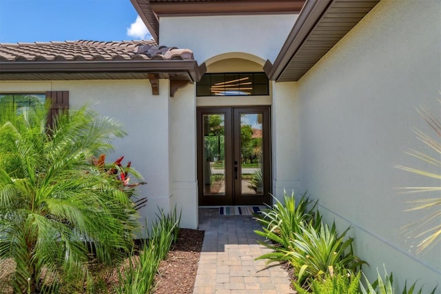 8020 Clearwater Ct, Sarasota, FL 34241 - property entrance featuring french doors, stucco siding, and a tile roof