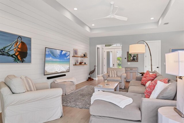 8020 Clearwater Ct, Sarasota, FL 34241 - living area featuring wood finished floors, wood walls, a raised ceiling, a ceiling fan, and recessed lighting