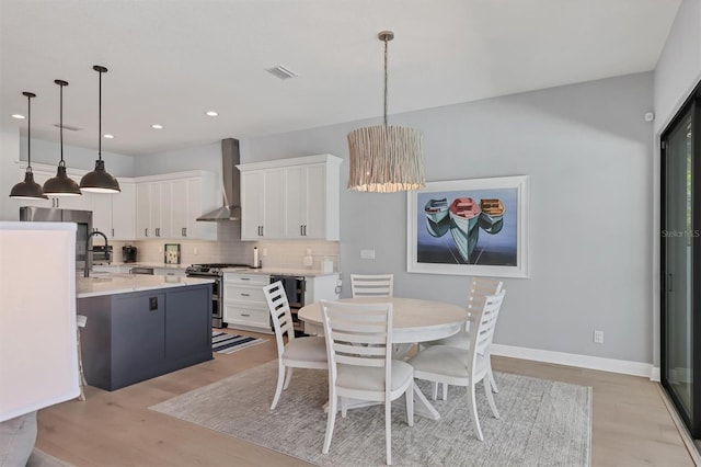 8020 Clearwater Ct, Sarasota, FL 34241 - dining space with light wood-type flooring, recessed lighting, baseboards, and a chandelier