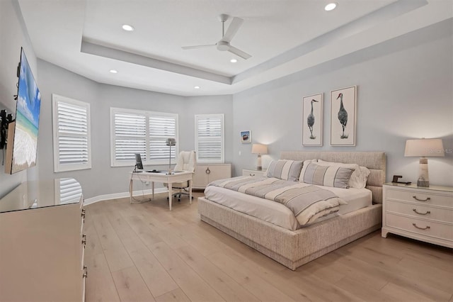 8020 Clearwater Ct, Sarasota, FL 34241 - bedroom featuring a raised ceiling, an office area, light wood-style flooring, recessed lighting, and a ceiling fan
