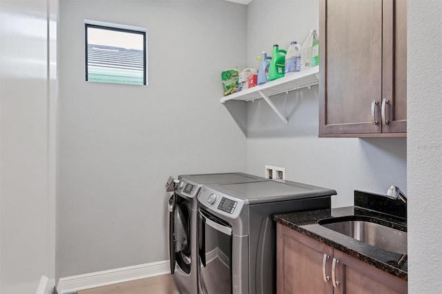 8020 Clearwater Ct, Sarasota, FL 34241 - laundry area featuring washing machine and clothes dryer, cabinet space, and baseboards