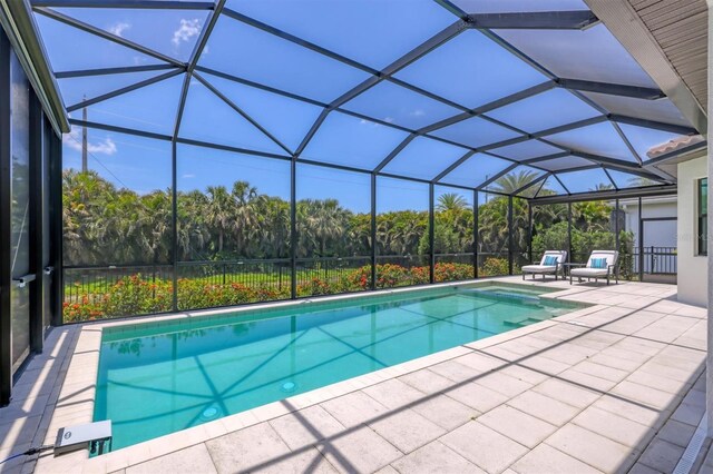 8020 Clearwater Ct, Sarasota, FL 34241 - outdoor pool featuring a patio, glass enclosure, and view of scattered trees