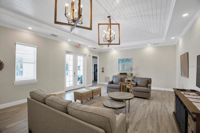 8020 Clearwater Ct, Sarasota, FL 34241 - living area with a chandelier, a tray ceiling, light wood-style floors, crown molding, and wood ceiling