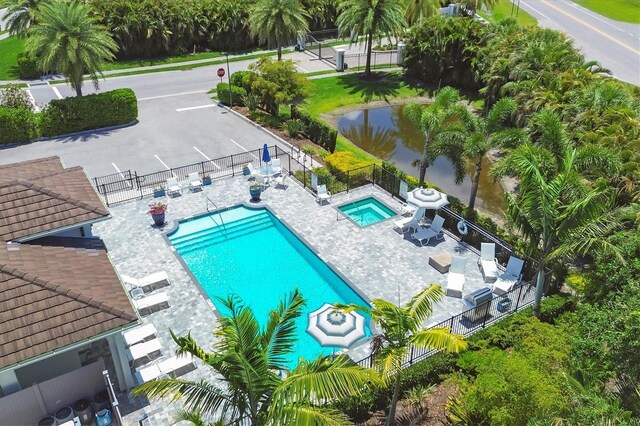 8020 Clearwater Ct, Sarasota, FL 34241 - community pool featuring a fenced backyard, a hot tub, and a patio area