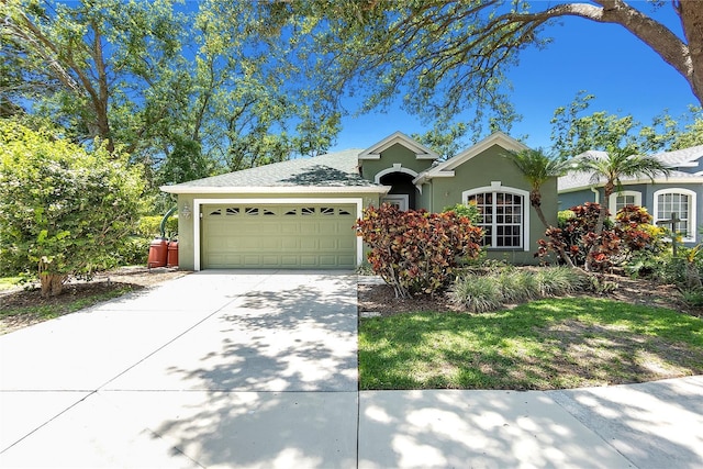 135 Tall Trees Ct, Sarasota, FL 34232 - view of front facade featuring an attached garage, stucco siding, and concrete driveway