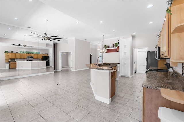 135 Tall Trees Ct, Sarasota, FL 34232 - kitchen with open shelves, light tile patterned floors, stainless steel microwave, ceiling fan, and recessed lighting