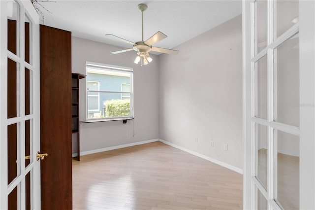 135 Tall Trees Ct, Sarasota, FL 34232 - spare room with wood finished floors, a ceiling fan, french doors, and baseboards