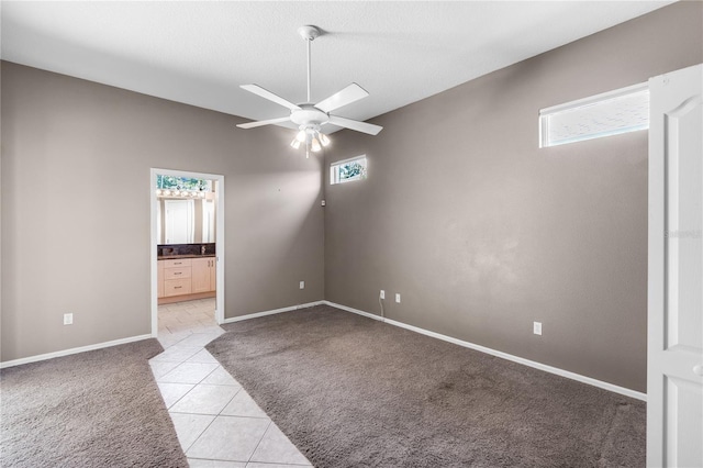 135 Tall Trees Ct, Sarasota, FL 34232 - spare room featuring light colored carpet, a ceiling fan, light tile patterned floors, and baseboards