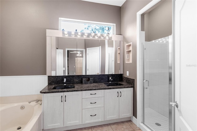 135 Tall Trees Ct, Sarasota, FL 34232 - bathroom featuring a stall shower, double vanity, a garden tub, ceiling fan, and tile patterned flooring