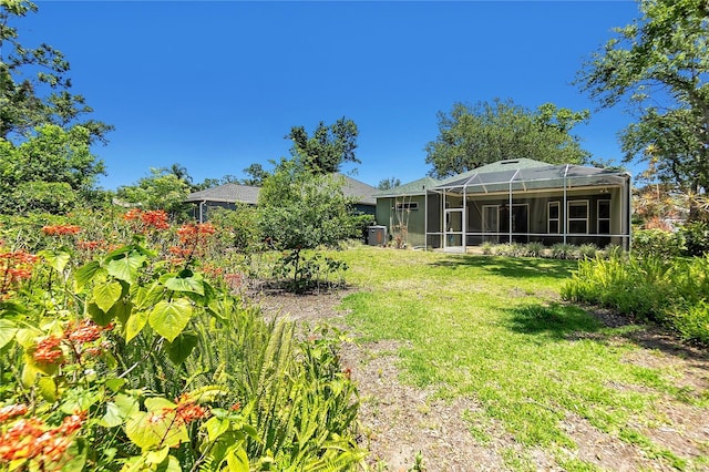135 Tall Trees Ct, Sarasota, FL 34232 - view of grassy yard with glass enclosure