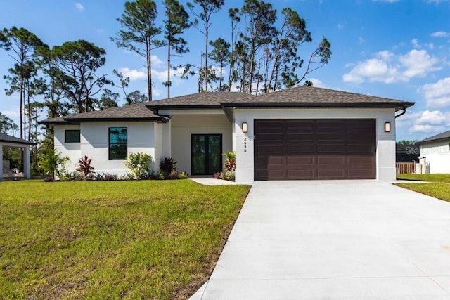 2638 Hagerick Ln, North Port, FL 34288 - prairie-style house featuring a garage, concrete driveway, a front lawn, and stucco siding