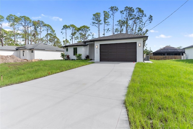 2638 Hagerick Ln, North Port, FL 34288 - view of front facade featuring a garage, stucco siding, driveway, and a front lawn