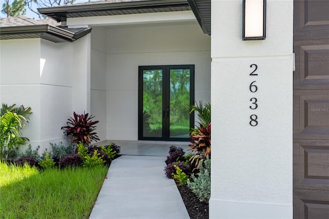 2638 Hagerick Ln, North Port, FL 34288 - entrance to property featuring french doors and stucco siding