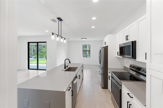 2638 Hagerick Ln, North Port, FL 34288 - kitchen with stainless steel appliances, a sink, a center island with sink, plenty of natural light, and recessed lighting