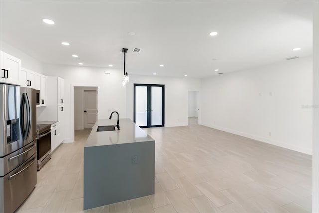 2638 Hagerick Ln, North Port, FL 34288 - kitchen featuring stainless steel appliances, a sink, white cabinetry, a center island with sink, and recessed lighting