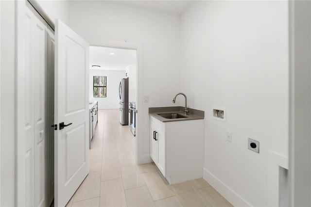 2638 Hagerick Ln, North Port, FL 34288 - laundry area with hookup for an electric dryer, hookup for a washing machine, cabinet space, light tile patterned floors, and baseboards