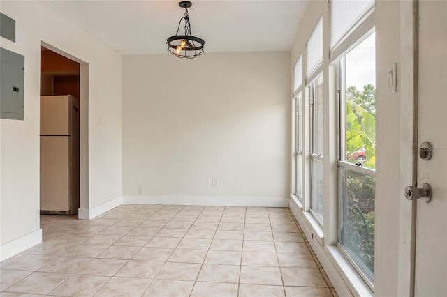 4475 Sandner Dr, Sarasota, FL 34243 - unfurnished dining area with light tile patterned floors, electric panel, and baseboards
