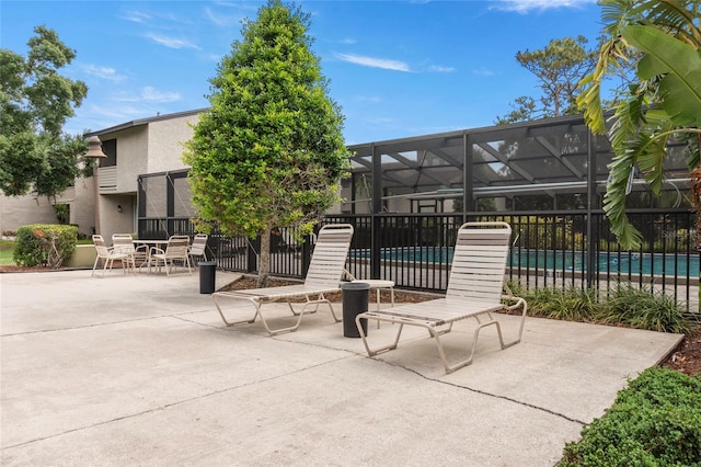 4475 Sandner Dr, Sarasota, FL 34243 - view of patio / terrace featuring a community pool and a lanai