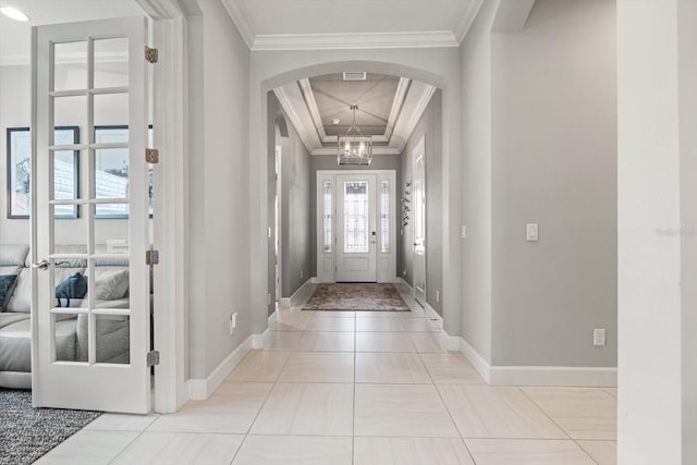 12856 Sorrento Way, Bradenton, FL 34211 - tiled entryway featuring arched walkways, baseboards, and crown molding