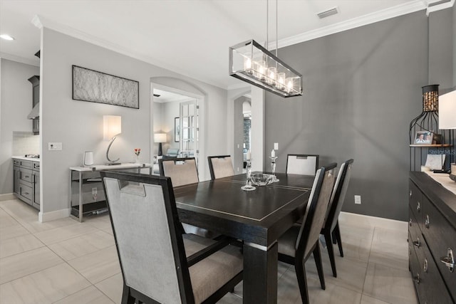 12856 Sorrento Way, Bradenton, FL 34211 - dining room featuring arched walkways, ornamental molding, baseboards, and light tile patterned floors