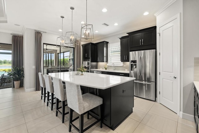 12856 Sorrento Way, Bradenton, FL 34211 - kitchen featuring stainless steel fridge, dark cabinetry, crown molding, light countertops, and a sink