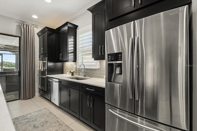 12856 Sorrento Way, Bradenton, FL 34211 - kitchen with stainless steel appliances, a sink, dark cabinetry, tasteful backsplash, and light countertops