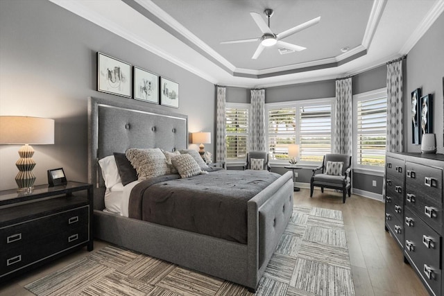 12856 Sorrento Way, Bradenton, FL 34211 - bedroom featuring a raised ceiling, ornamental molding, wood finished floors, baseboards, and a ceiling fan