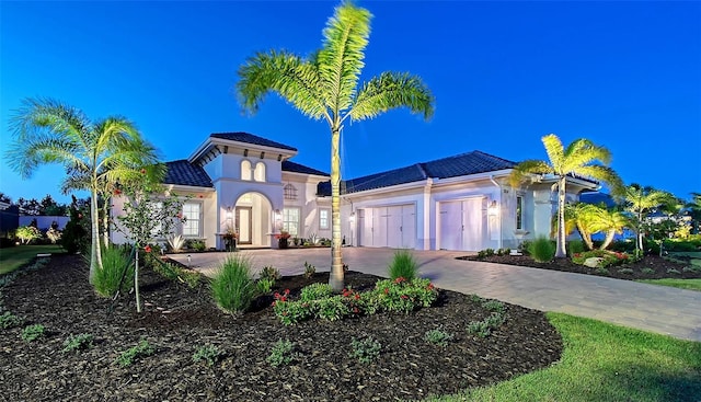 7838 Bowspirit Way, Lakewood Ranch, FL 34202 - mediterranean / spanish-style home with driveway, an attached garage, stucco siding, and a tiled roof