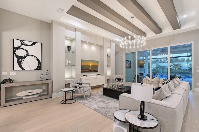 7838 Bowspirit Way, Lakewood Ranch, FL 34202 - living area featuring light wood-style flooring, built in shelves, a chandelier, and baseboards