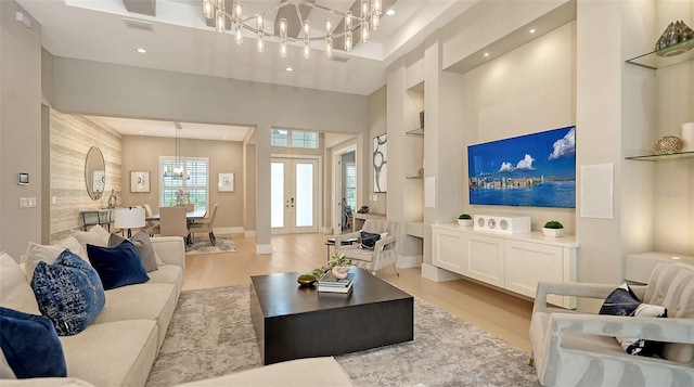 7838 Bowspirit Way, Lakewood Ranch, FL 34202 - living area with a chandelier, light wood finished floors, built in features, recessed lighting, and an accent wall