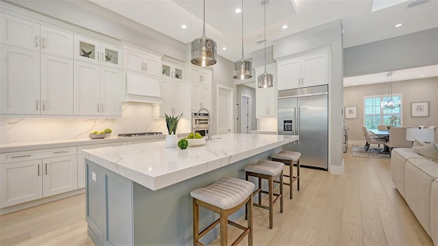 7838 Bowspirit Way, Lakewood Ranch, FL 34202 - kitchen featuring stainless steel appliances, light wood-type flooring, white cabinets, backsplash, and recessed lighting