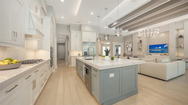 7838 Bowspirit Way, Lakewood Ranch, FL 34202 - kitchen featuring light wood finished floors, open floor plan, white cabinets, a large island, and recessed lighting