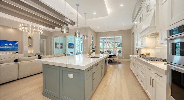7838 Bowspirit Way, Lakewood Ranch, FL 34202 - kitchen featuring a sink, custom range hood, a chandelier, light wood-type flooring, and recessed lighting