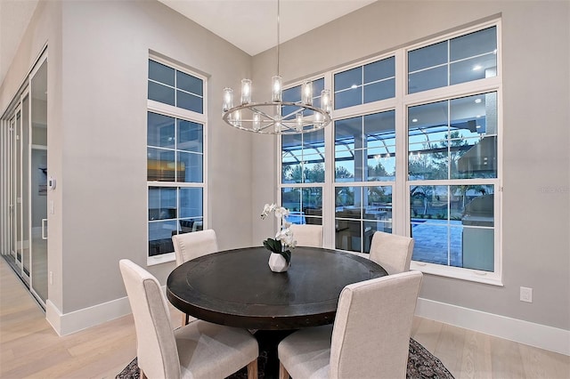 7838 Bowspirit Way, Lakewood Ranch, FL 34202 - dining area with a chandelier, baseboards, and light wood-type flooring