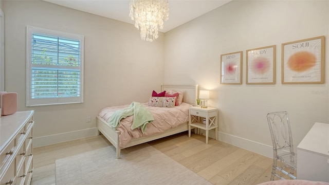 7838 Bowspirit Way, Lakewood Ranch, FL 34202 - bedroom with baseboards, a chandelier, and wood finished floors