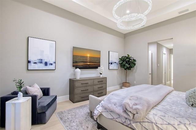 7838 Bowspirit Way, Lakewood Ranch, FL 34202 - bedroom featuring a chandelier, light wood-type flooring, and baseboards