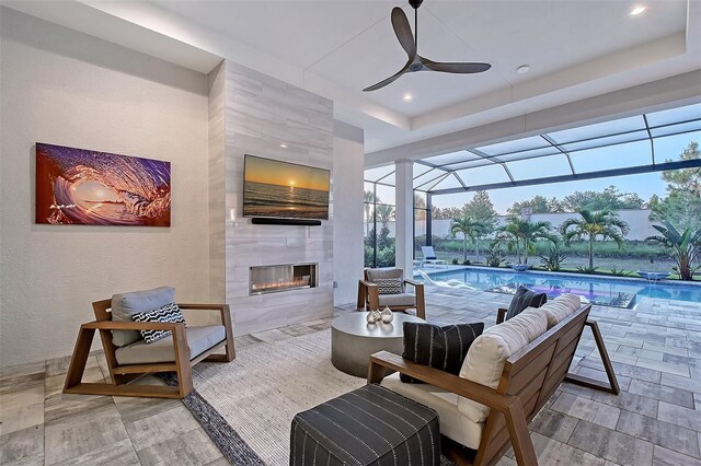 7838 Bowspirit Way, Lakewood Ranch, FL 34202 - view of patio featuring ceiling fan, an outdoor pool, and an outdoor living space with a fireplace