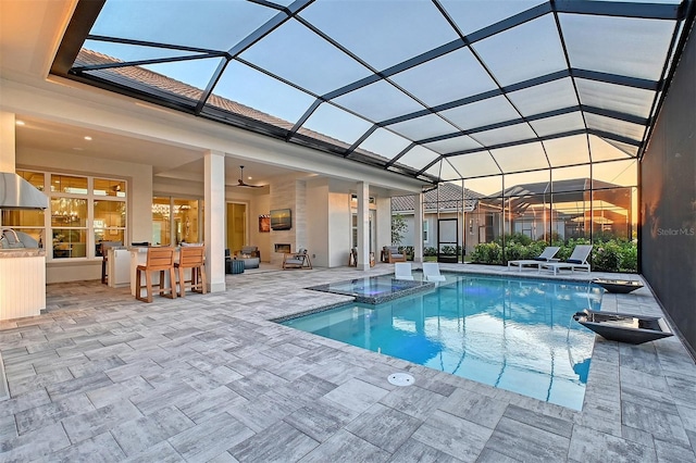 7838 Bowspirit Way, Lakewood Ranch, FL 34202 - view of pool featuring a patio area, a pool with connected hot tub, an outdoor kitchen, and a lanai