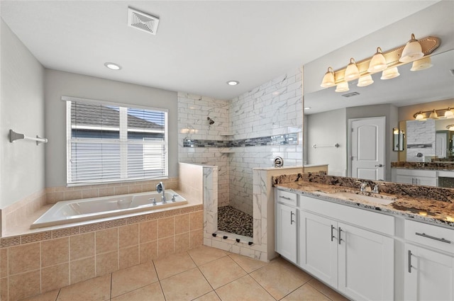5224 58th Ter E, Bradenton, FL 34203 - bathroom with a bath, vanity, a walk in shower, and tile patterned floors