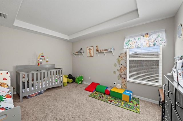 5224 58th Ter E, Bradenton, FL 34203 - bedroom with a tray ceiling, carpet floors, a nursery area, and baseboards